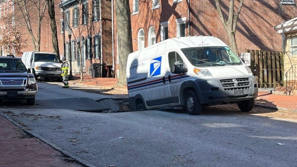 Mail truck partially falls into sinkhole in Wilmington, Delaware