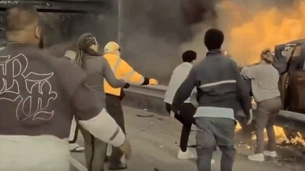 Dramatic dashcam video shows good Samaritans, including a postal worker, rush to pull man from burning car