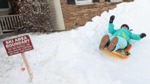 This DeWitt mailman loves snow so much, he’s turned his yard into sledding trails for the kids