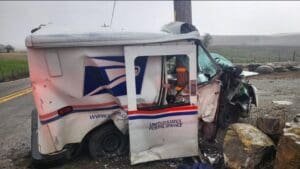 Mail Truck Crashes Into Pole, Causing Major Injuries & Road Closure