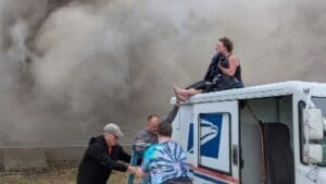 Mail carrier uses truck to help trapped woman escape Indiana house fire