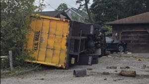Mail Truck Overturns After Striking Parked Vehicles