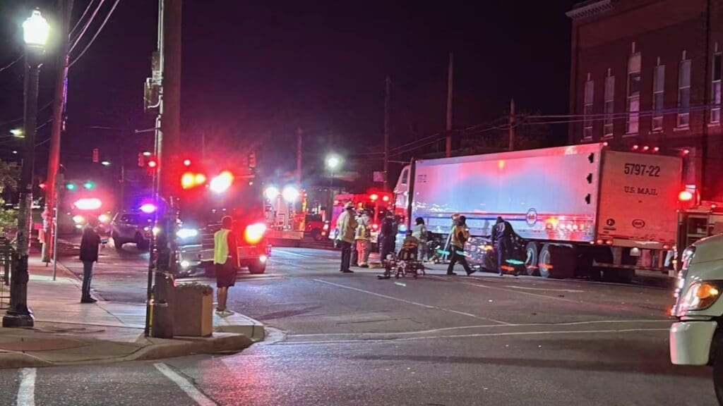 Car trapped under postal service 18-wheeler in Avondale area, 3 injured